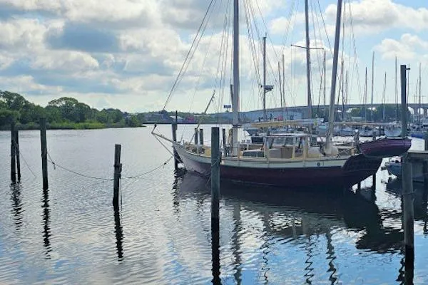 Tien Hou Yacht Photos Pics Sailboat docked at marina, Parker Marine Enterprises Lorcha 50, 2002 model, calm water, cloudy sky.