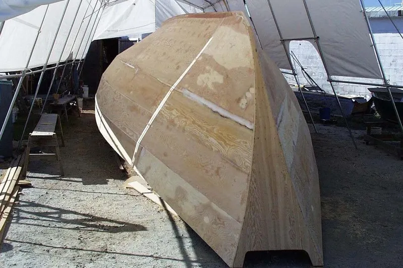 Tien Hou Yacht Photos Pics Wooden hull construction of a 2002 Parker Marine Enterprises Lorcha 50 under a tent.