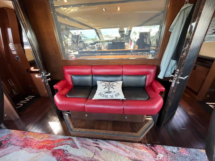 Izumi Yacht Photos Pics Luxurious interior of 2008 Palmer Johnson 120 yacht with red leather seating and nautical decor.