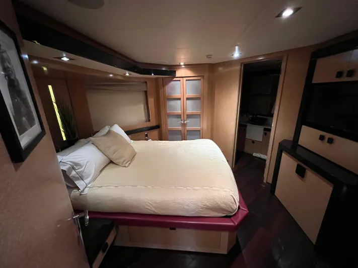 Izumi Yacht Photos Pics Luxurious bedroom interior on 2008 Palmer Johnson 120 yacht, featuring elegant design and cozy ambiance.