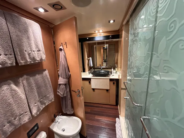 Izumi Yacht Photos Pics Luxurious bathroom in a 2008 Palmer Johnson 120 yacht, featuring elegant wood and frosted glass.