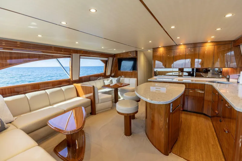 Da'grits Yacht Photos Pics Luxurious interior of 2018 Viking 62 Convertible yacht with elegant wood finishes and ocean view.