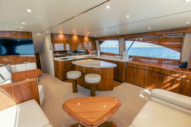 Da'grits Yacht Photos Pics Luxurious interior of 2018 Viking 62 Convertible yacht with elegant wood finishes and ocean view.