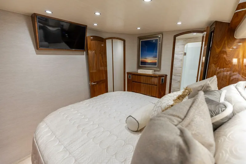 Da'grits Yacht Photos Pics Luxurious bedroom interior of 2018 Viking 62 Convertible yacht with elegant decor and modern amenities.