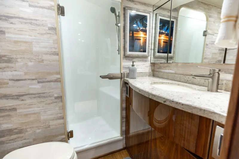 Da'grits Yacht Photos Pics Luxurious bathroom in 2018 Viking 62 Convertible yacht with modern fixtures and elegant design.