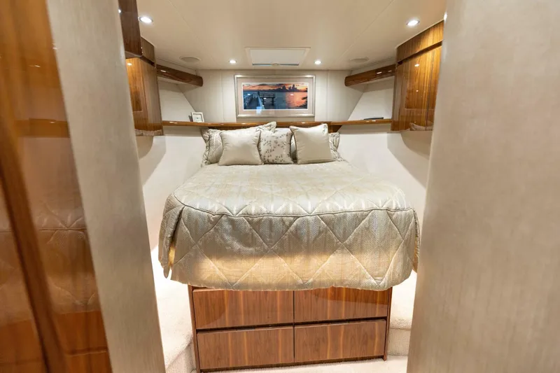 Da'grits Yacht Photos Pics Luxurious bedroom interior of 2018 Viking 62 Convertible yacht with elegant bedding and wood accents.