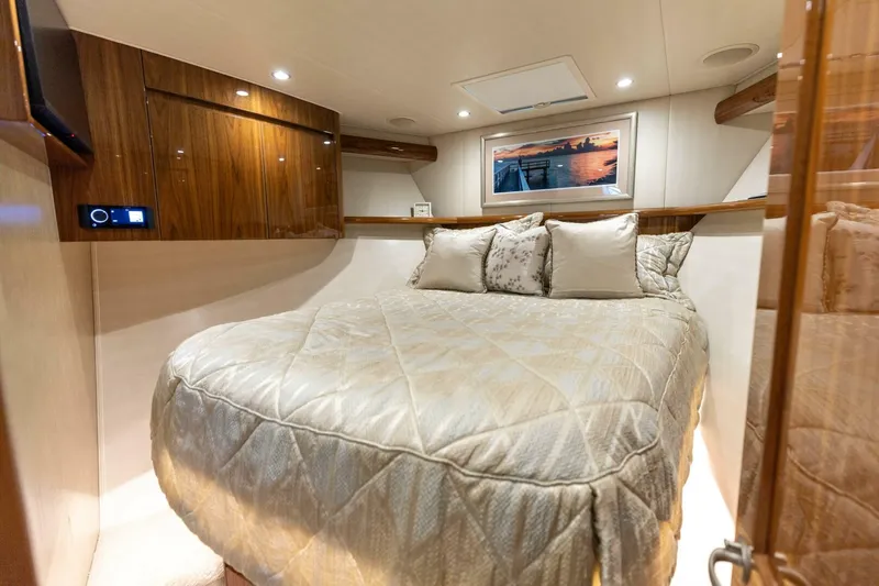 Da'grits Yacht Photos Pics Luxurious bedroom interior of 2018 Viking 62 Convertible yacht with elegant bedding and wood accents.