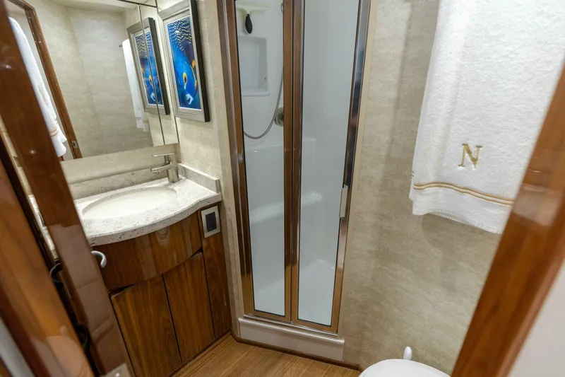 Da'grits Yacht Photos Pics Luxurious bathroom in 2018 Viking 62 Convertible yacht with shower and elegant wood finishes.