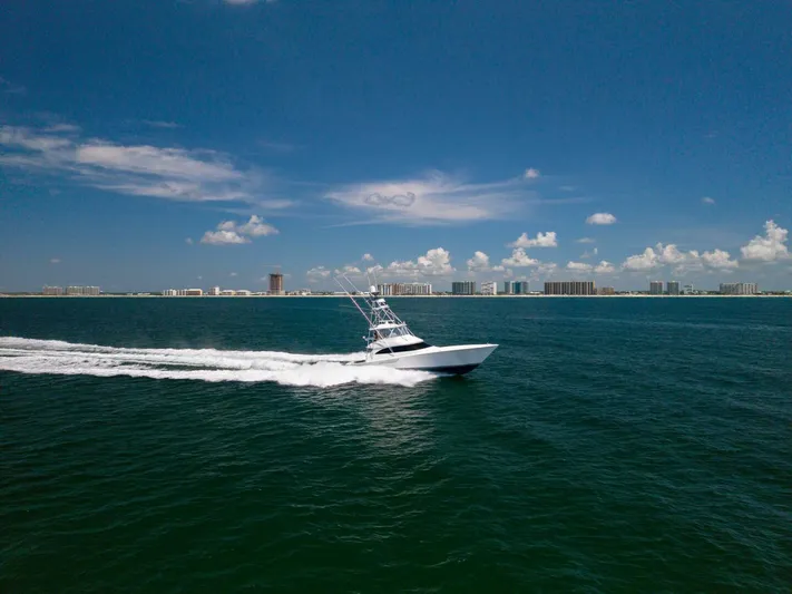 Da'grits Yacht Photos Pics 2018 Viking 62 Convertible yacht cruising on open sea under clear blue sky.