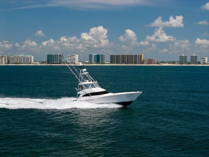 Da'grits Yacht Photos Pics 2018 Viking 62 Convertible yacht cruising on ocean near city skyline.