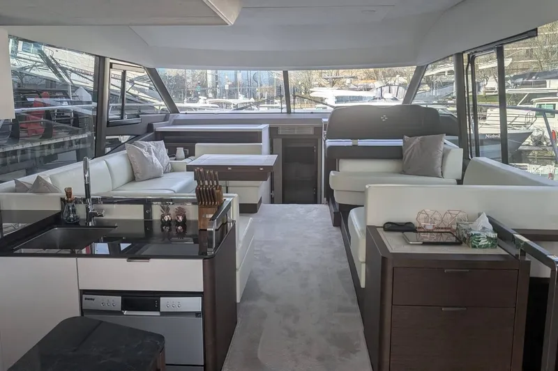  Yacht Photos Pics Luxurious interior of 2022 Prestige 590 yacht with modern furnishings and panoramic windows.