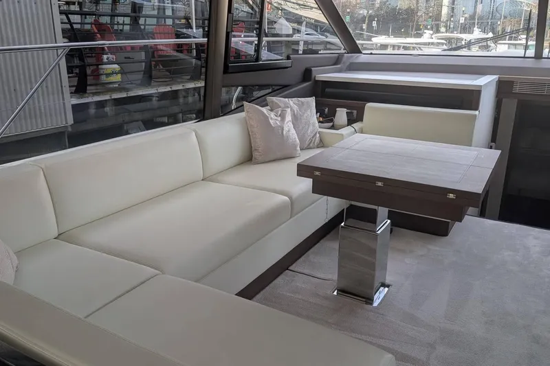  Yacht Photos Pics Luxurious interior of 2022 Prestige 590 yacht with elegant seating and modern table.