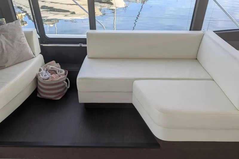  Yacht Photos Pics Luxurious white seating area on 2022 Prestige 590 yacht interior.