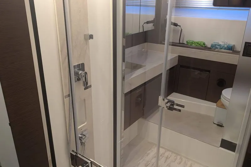  Yacht Photos Pics Luxurious bathroom in 2022 Prestige 590 yacht with modern shower and sleek fixtures.