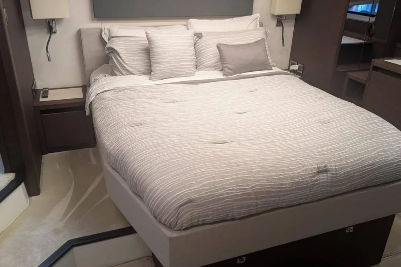  Yacht Photos Pics Luxurious bedroom interior of 2022 Prestige 590 yacht with elegant bedding and modern decor.