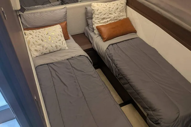  Yacht Photos Pics Twin beds in a 2022 Prestige 590 yacht cabin with elegant gray bedding.