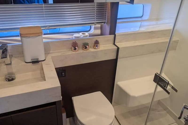  Yacht Photos Pics Luxurious bathroom in 2022 Prestige 590 yacht with modern fixtures and decor.