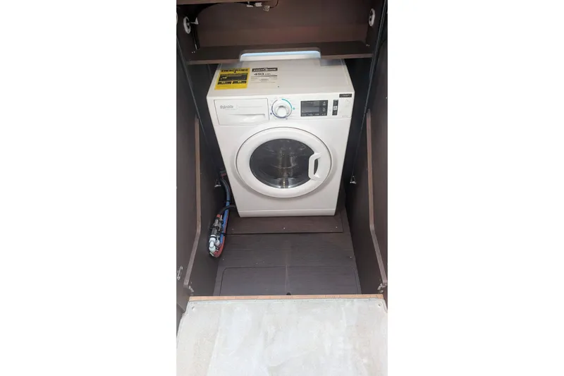  Yacht Photos Pics 2022 Prestige 590 washing machine in a compact, enclosed space.