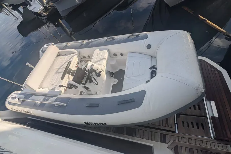  Yacht Photos Pics 2022 Prestige 590 yacht with Williams tender docked on water.