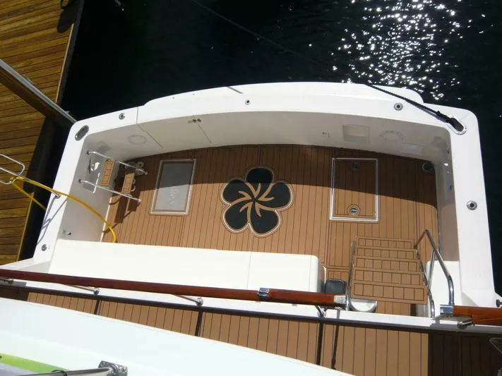 Vitamin Sea Yacht Photos Pics 1990 Viking Cockpit Motor Yacht deck with wood finish and decorative design.