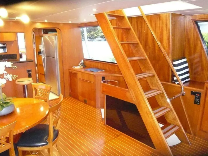 Vitamin Sea Yacht Photos Pics Luxurious 1990 Viking Cockpit Motor Yacht interior with wooden finishes and modern amenities.