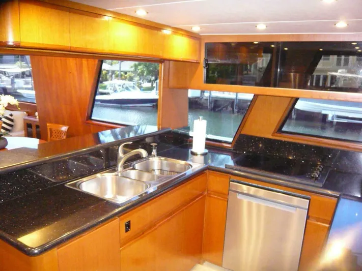 Vitamin Sea Yacht Photos Pics Luxurious kitchen interior of 1990 Viking Cockpit Motor Yacht with sleek countertops and modern appliances.