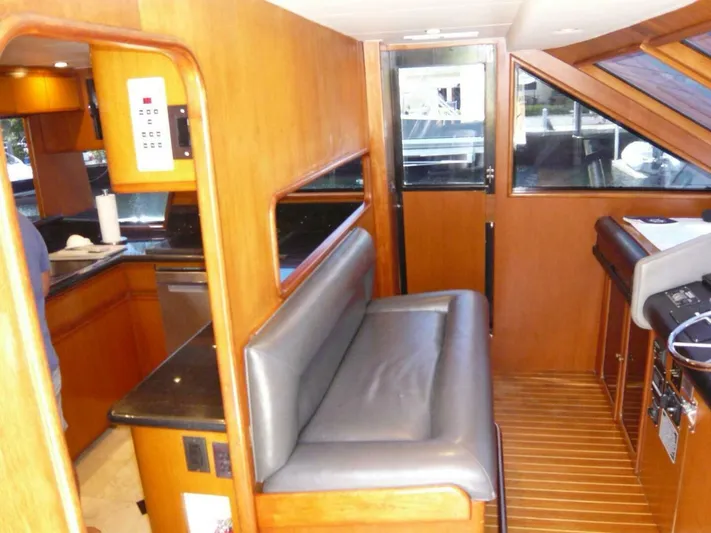 Vitamin Sea Yacht Photos Pics 1990 Viking Cockpit Motor Yacht interior with wood paneling and seating area.