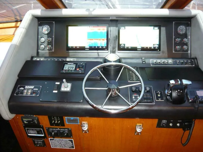 Vitamin Sea Yacht Photos Pics Cockpit of 1990 Viking Motor Yacht with navigation screens and steering wheel.