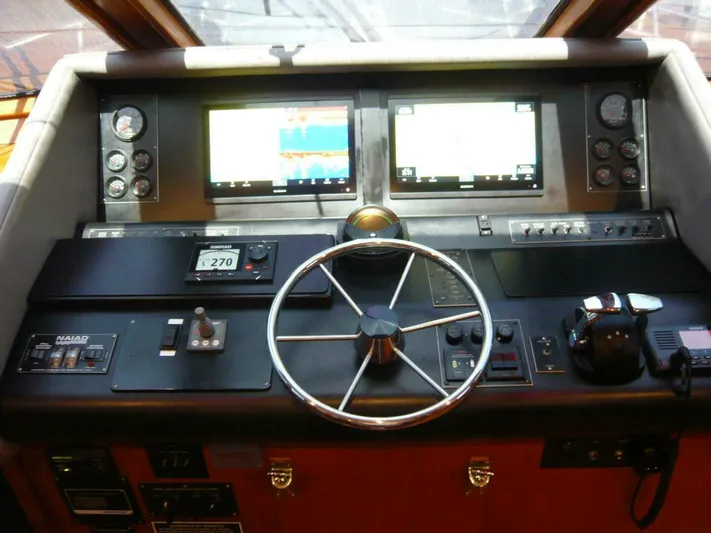 Vitamin Sea Yacht Photos Pics Cockpit of 1990 Viking Motor Yacht with steering wheel and navigation displays.