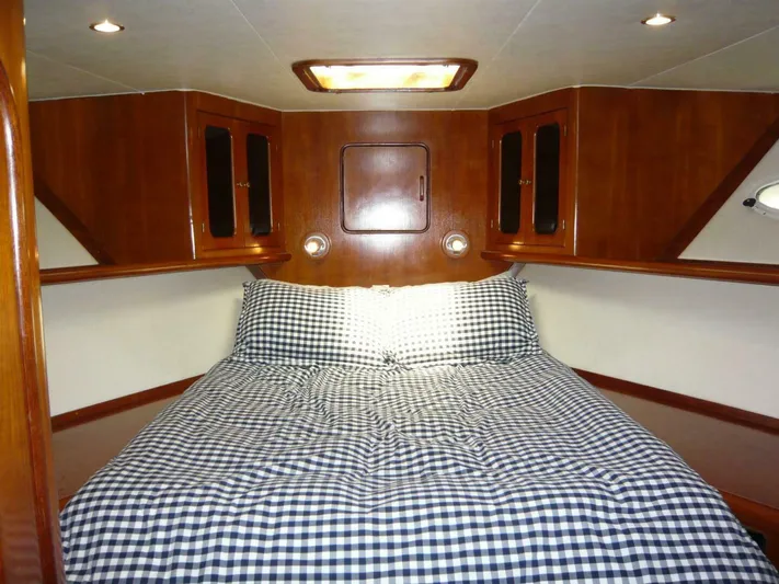 Vitamin Sea Yacht Photos Pics Cozy cabin interior of 1990 Viking Cockpit Motor Yacht with checkered bedding.