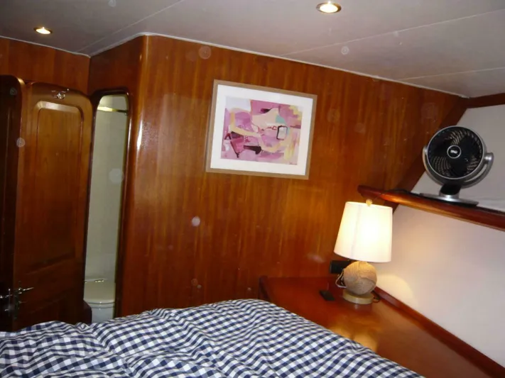 Vitamin Sea Yacht Photos Pics Cozy cabin interior of 1990 Viking Cockpit Motor Yacht with wood paneling and modern decor.
