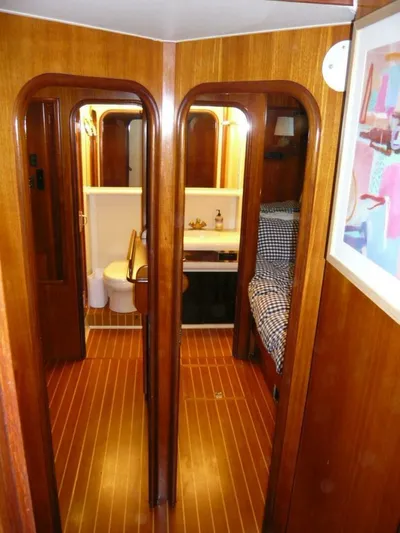 Vitamin Sea Yacht Photos Pics 1990 Viking Cockpit Motor Yacht interior with wood paneling, bathroom, and cozy sleeping area.