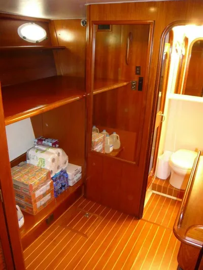 Vitamin Sea Yacht Photos Pics Interior of 1990 Viking Cockpit Motor Yacht with wooden cabinetry and stocked supplies.