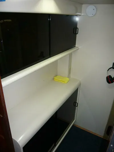 Vitamin Sea Yacht Photos Pics Interior of 1990 Viking Cockpit Motor Yacht with storage shelves and cabinets.