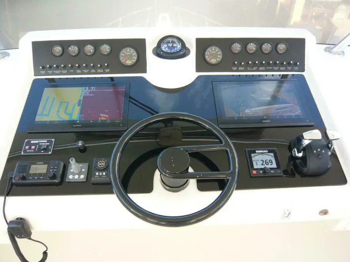 Vitamin Sea Yacht Photos Pics Cockpit of 1990 Viking Motor Yacht with navigation instruments and steering wheel.
