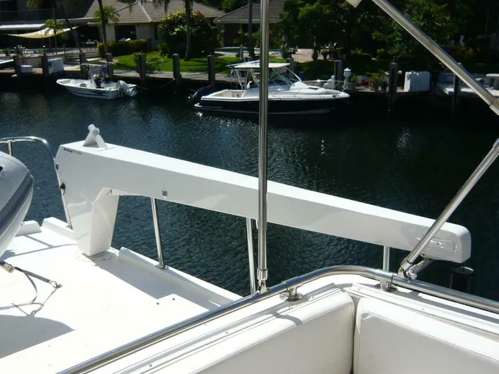 Vitamin Sea Yacht Photos Pics 1990 Viking Cockpit Motor Yacht deck with davit, overlooking marina.