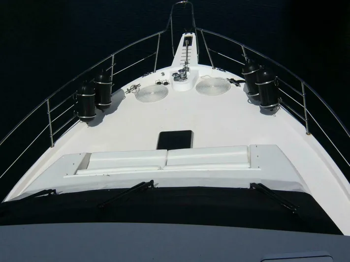 Vitamin Sea Yacht Photos Pics Bow view of a 1990 Viking Cockpit Motor Yacht, featuring deck details and railing.