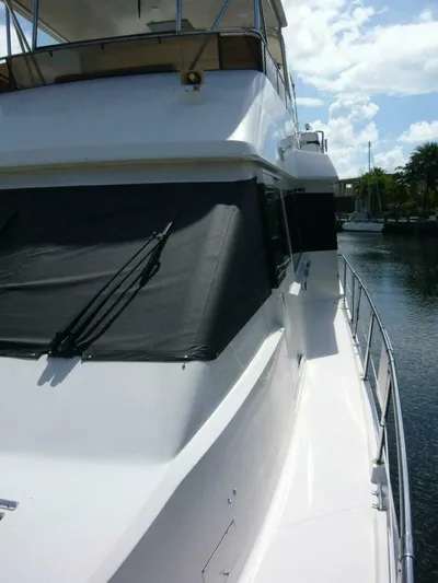 Vitamin Sea Yacht Photos Pics 1990 Viking Cockpit Motor Yacht docked, featuring sleek white exterior and covered windows.