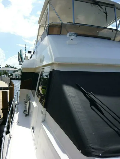 Vitamin Sea Yacht Photos Pics 1990 Viking Cockpit Motor Yacht docked, showcasing sleek design and upper deck.