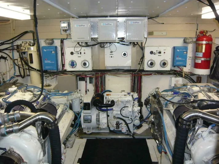 Vitamin Sea Yacht Photos Pics Engine room of a 1990 Viking Cockpit Motor Yacht with complex machinery and control panels.