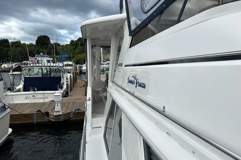  Yacht Photos Pics 1998 Carver 445 Aft Cabin Motor Yacht docked at marina under cloudy sky.
