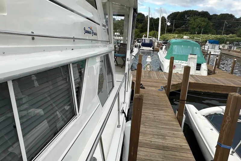  Yacht Photos Pics 1998 Carver 445 Aft Cabin Motor Yacht docked at marina, side view.