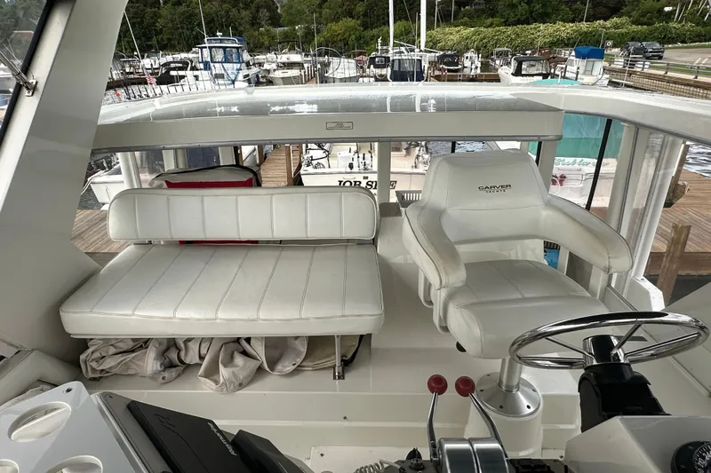  Yacht Photos Pics 1998 Carver 445 Aft Cabin Motor Yacht helm with white seating at marina.