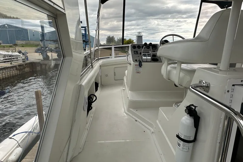  Yacht Photos Pics 1998 Carver 445 Aft Cabin Motor Yacht helm with steering wheel and controls, dockside view.