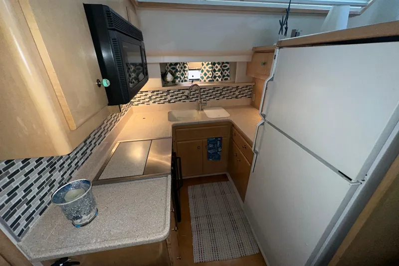  Yacht Photos Pics Compact kitchen in 1998 Carver 445 Aft Cabin Motor Yacht with modern appliances.