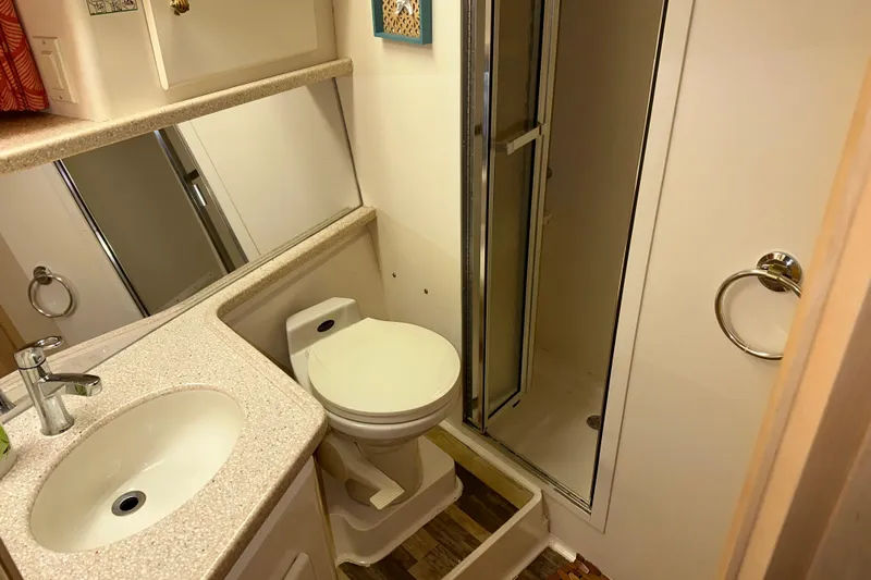  Yacht Photos Pics 1998 Carver 445 Aft Cabin Motor Yacht bathroom with sink, toilet, and shower.