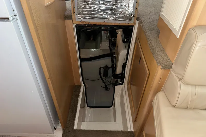  Yacht Photos Pics 1998 Carver 445 Aft Cabin Motor Yacht interior, showing engine access hatch and seating area.