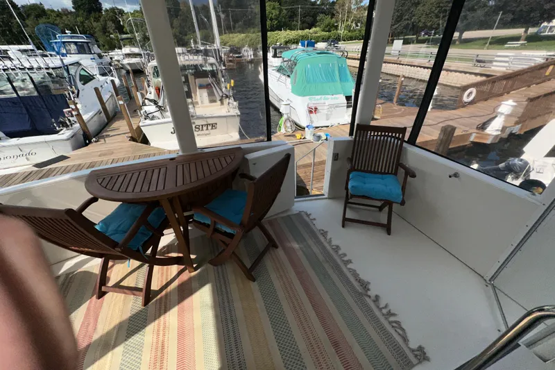  Yacht Photos Pics 1998 Carver 445 Aft Cabin Motor Yacht with outdoor seating and marina view.