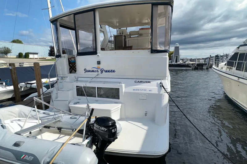  Yacht Photos Pics 1998 Carver 445 Aft Cabin Motor Yacht docked, featuring "Summer Breeze" name and inflatable boat.