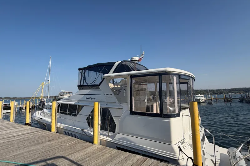  Yacht Photos Pics 1998 Carver 445 Aft Cabin Motor Yacht docked at marina under clear blue sky.